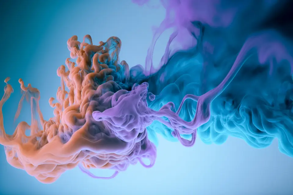 Teal and coral ink dispersing through water in slow curling trails, representing smooth motion on a web page.