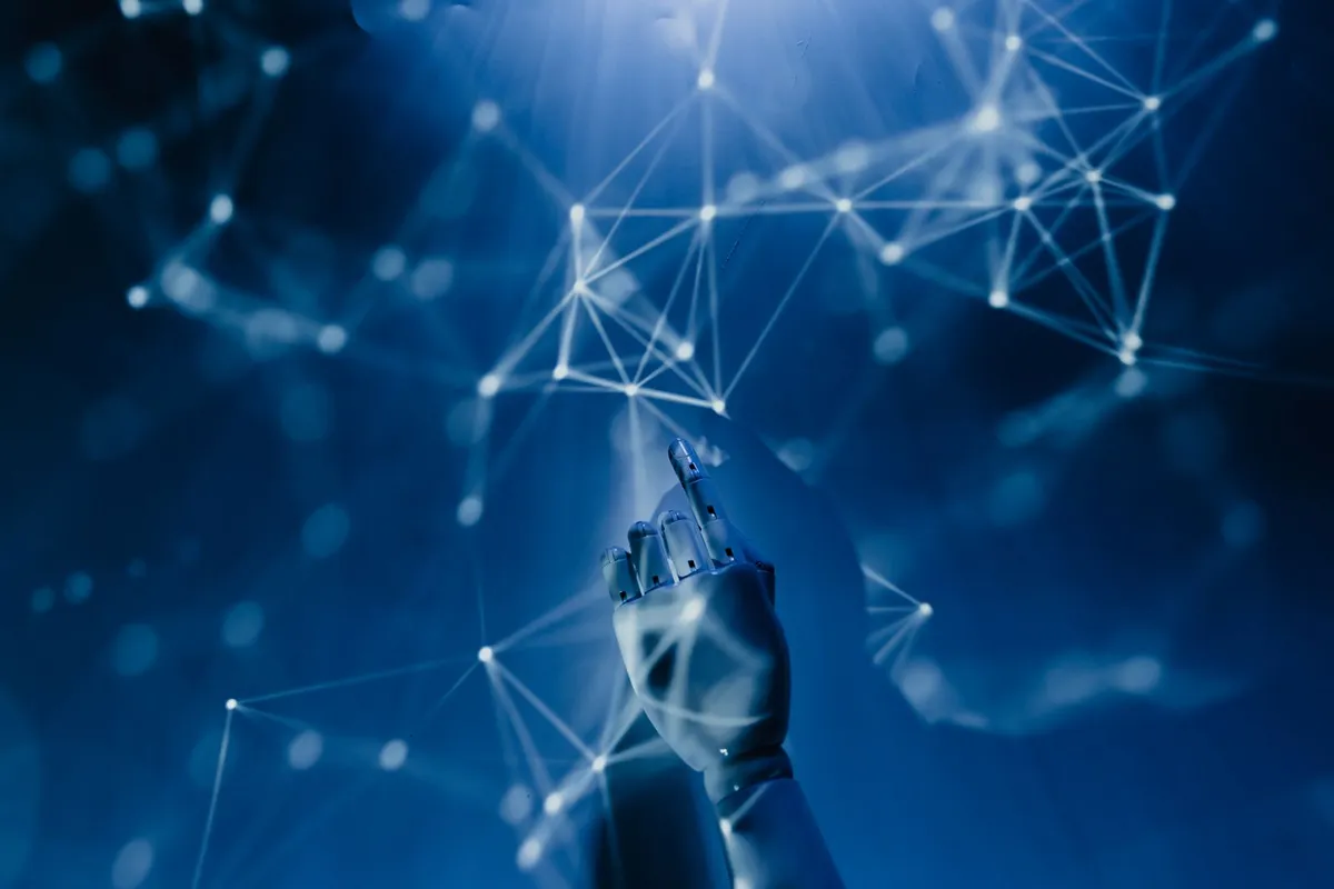 A robotic hand reaching into a glowing digital network, representing automated bots targeting website contact forms and the need for spam protection.