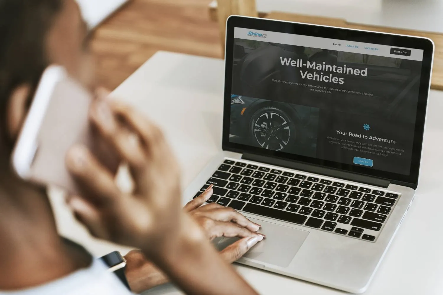 User interacting with the Shinerz car rental platform on a laptop, highlighting the professional 'Well-Maintained Vehicles' section.